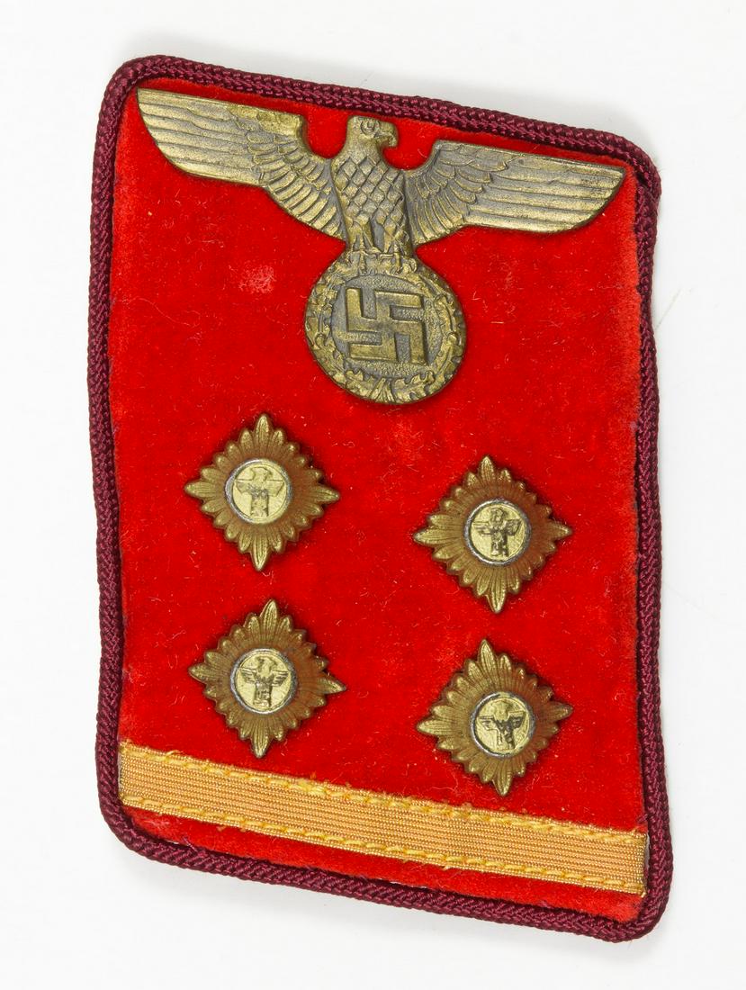NSDAP "REICHSLEITUNG OBERGEMEINSCHAFTSLEITER" COLLAR: Original NSDAP collar tab, 2.5 in. x 1.75 in., constructed of red velvet over a buckram core, indicating the party level of 'Reichsleitung'. The tab is piped in dark red, and displays a brass national