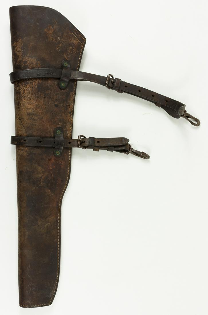 M1938 RIFLE SCABBARD FOR M1 GARAND: Original brown leather M1938 rifle scabbard, approx. 30 x 7 ¾', designed to hold the M1 Garand rifle used by U.S. military forces during World War II. The scabbard consists of a single piece of