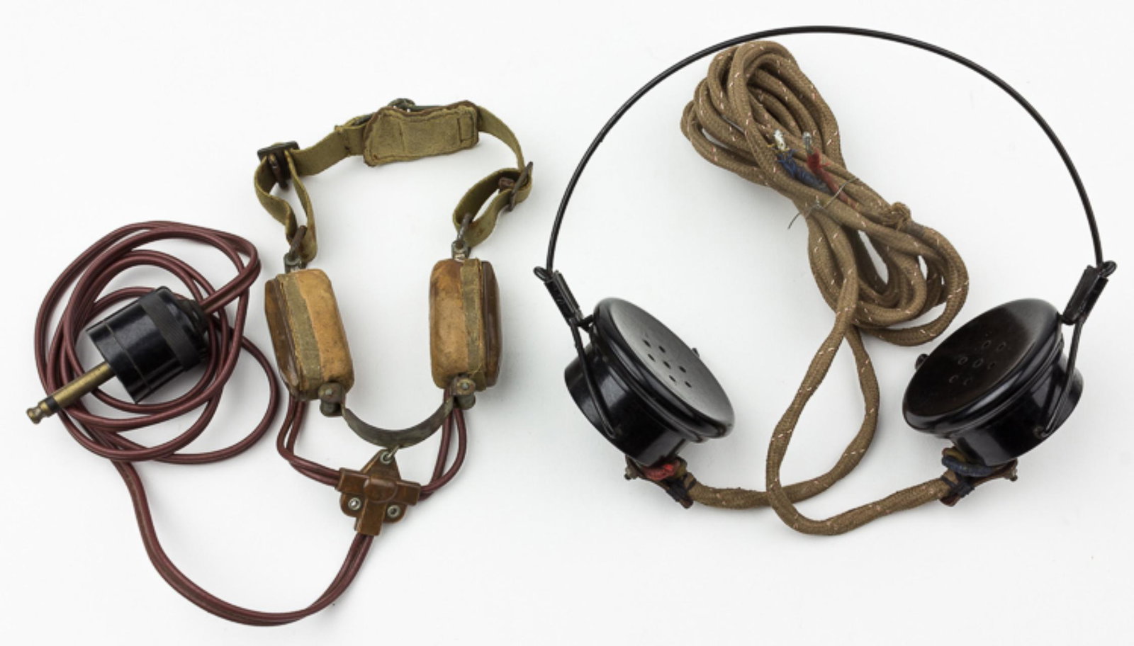 BRITISH RADIO MAN'S THROAT MIC AND HEADSET: Pair of electrical communication items used by British soldiers World War II, includes a W38 Mk. II throat mic with plug-in connector, along with a headset with bakelite casings marked: 'S.G. B C.L. R