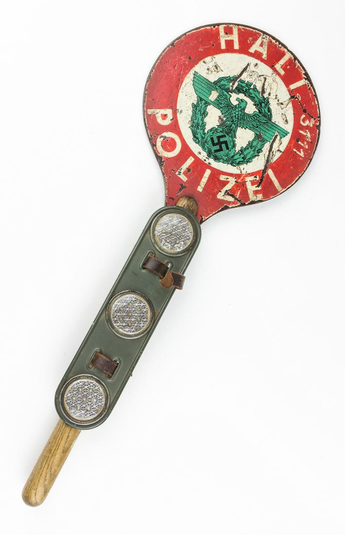 GERMAN POLIZEI "HALT" HAND-HELD TRAFFIC SIGN: A rare hand-held sign used by the German police, 21' long overall with a 7' painted steel disc at the end of a wood handle. The disc bears the green eagle and swastika representing the 'Ordnungspolize