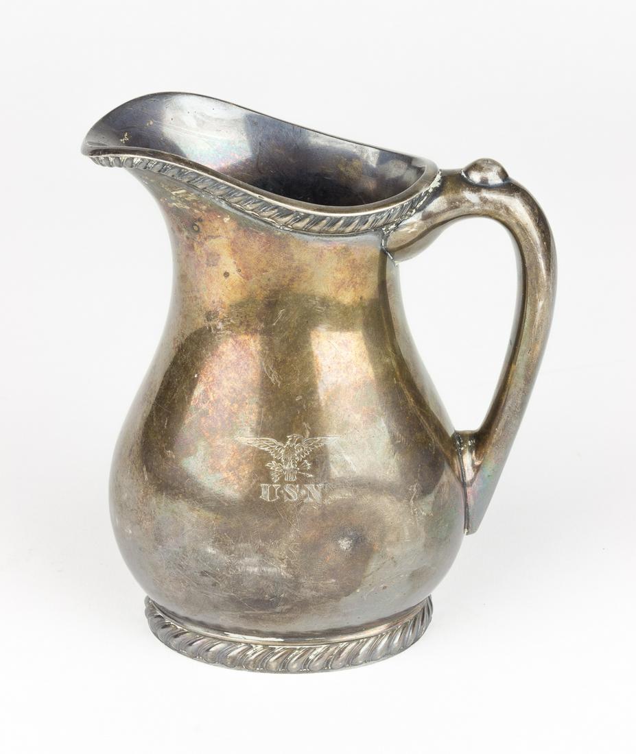 U.S. NAVY SILVER CREAMER: Silver creamer, approx. 5 3/4' x 4 1/2' x 3', bearing on one side the engraved initials 'U.S.N. (for 'U.S. Navy') beneath an American eagle. The base bear's the manufacturer's name 'international Silv