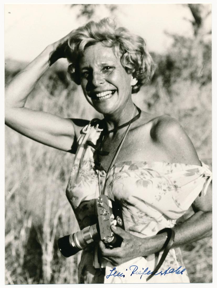LENI RIEFENSTAHL: (1902 - 2003) German film director, an intimate friend of Hitler who filmed the propaganda classic, "Triumph of the Will." S.P., 5 x 7 in. b/w, a casual pose with camera signed on front and initialed 