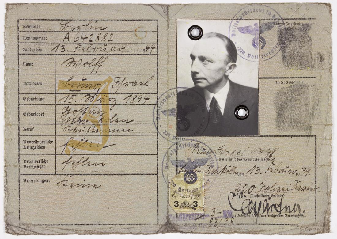 GERMAN "J" IDENTITY CARD ISSUED TO A JEW: Uncommon partly-printed D.S., 4pp. 12mo., Berlin, Feb. 13, 1939, a "Kennkarte" issued to Bruno "Israel" Wolff, a businessman born in 1894. The book is stamped "J" on the cover and again within, signif
