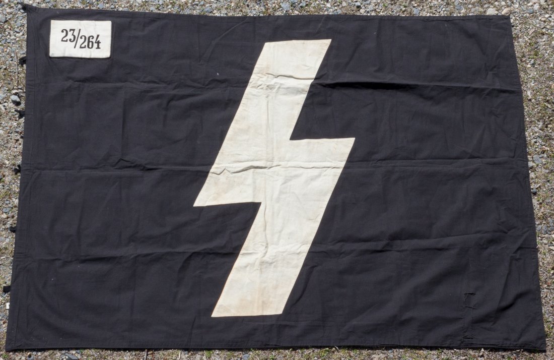 DEUTSCHES JUNGVOLK UNIT FLAG: Large black flag, 59.5 x 46 in, with the insignia of the DJ, a white cloth "Sig" rune, and a unit patch"23/263"Â applied to each side. The hoist bears six broken cloth hanging loops. Minor soiling to