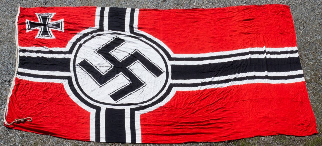 GERMAN "REICHSKRIEGSFLAGGE": Third Reich Reichskriegsflagge, 8 x 15 ft., constructed of red wool bunting with a black and white cross offset towards the hoist, with a black mobile swastika within a white disk at the center, and a