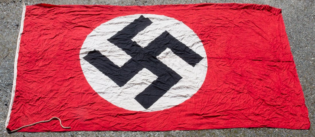 THIRD REICH NAVAL JACK: Third Reich flag, 118 x 196 in., a "Goesch", or naval jack, flown from the bow of German-flagged warships and merchant shipping. The flag is constructed of red wool bunting with a clamp-dyed black mob