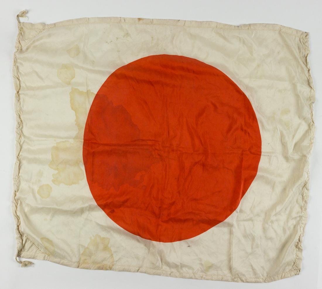 JAPANESE NATIONAL "MEATBALL" FLAG: Silk Japanese national flag, 35 x 30 in., clamp-dyed with a red"hinomaru"Â sun symbol at center. Hoist contains a white cord. Minor staining overall, else very good.