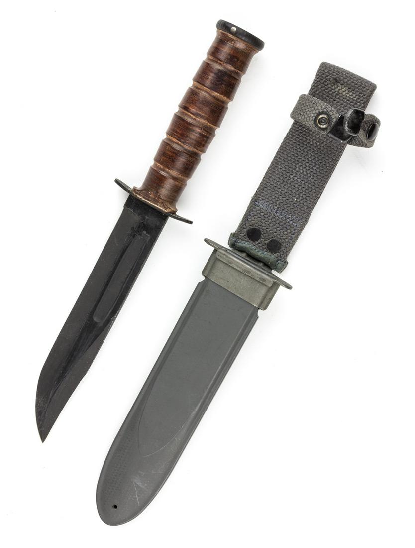 U.S. NAVY MARK 2 FIGHTING KNIFE BY CAMILLUS: World War II U.S. Navy Mark 2 fighting knife, 7" blade, 12" overall, with a pinned steel pommel and a grip constructed of knurled brown leather washers. The hand guard bears the maker's mark"U.S.N. MA