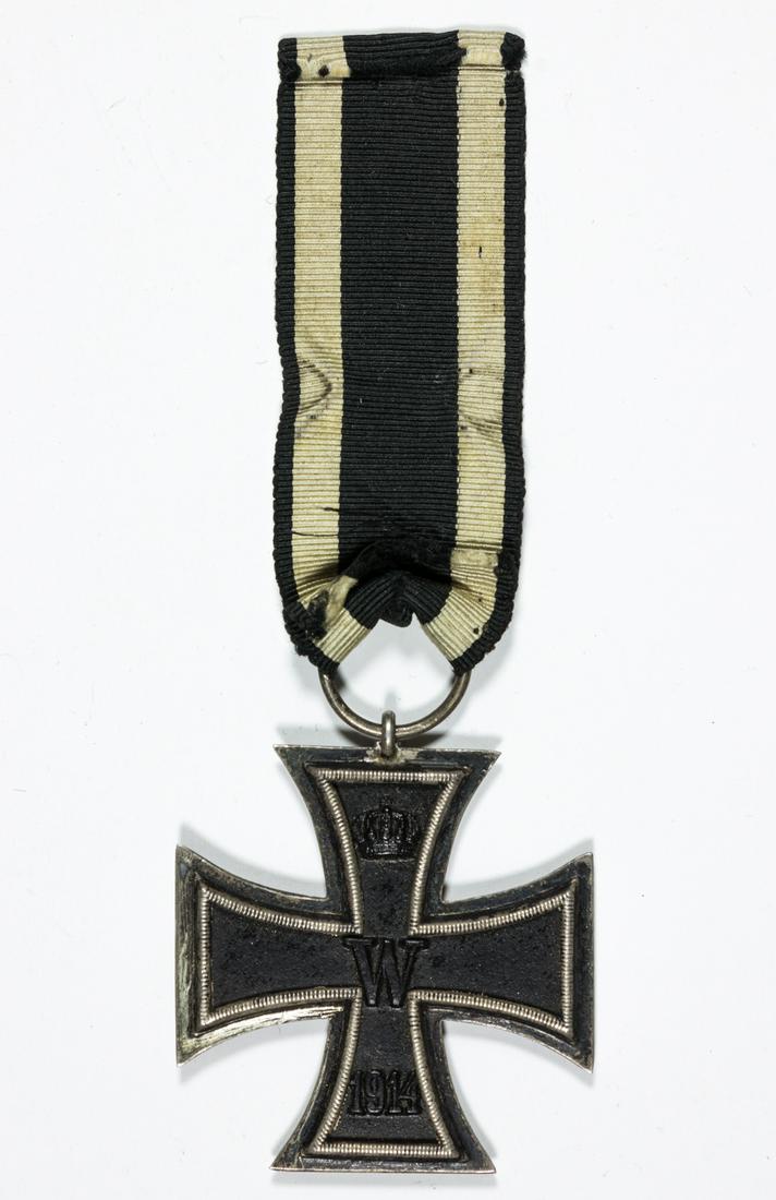 IRON CROSS, SECOND CLASS: 1914 Iron Cross, 2nd Class, unmarked with original ring and ribbon, worn near the edges, with ribbon.
