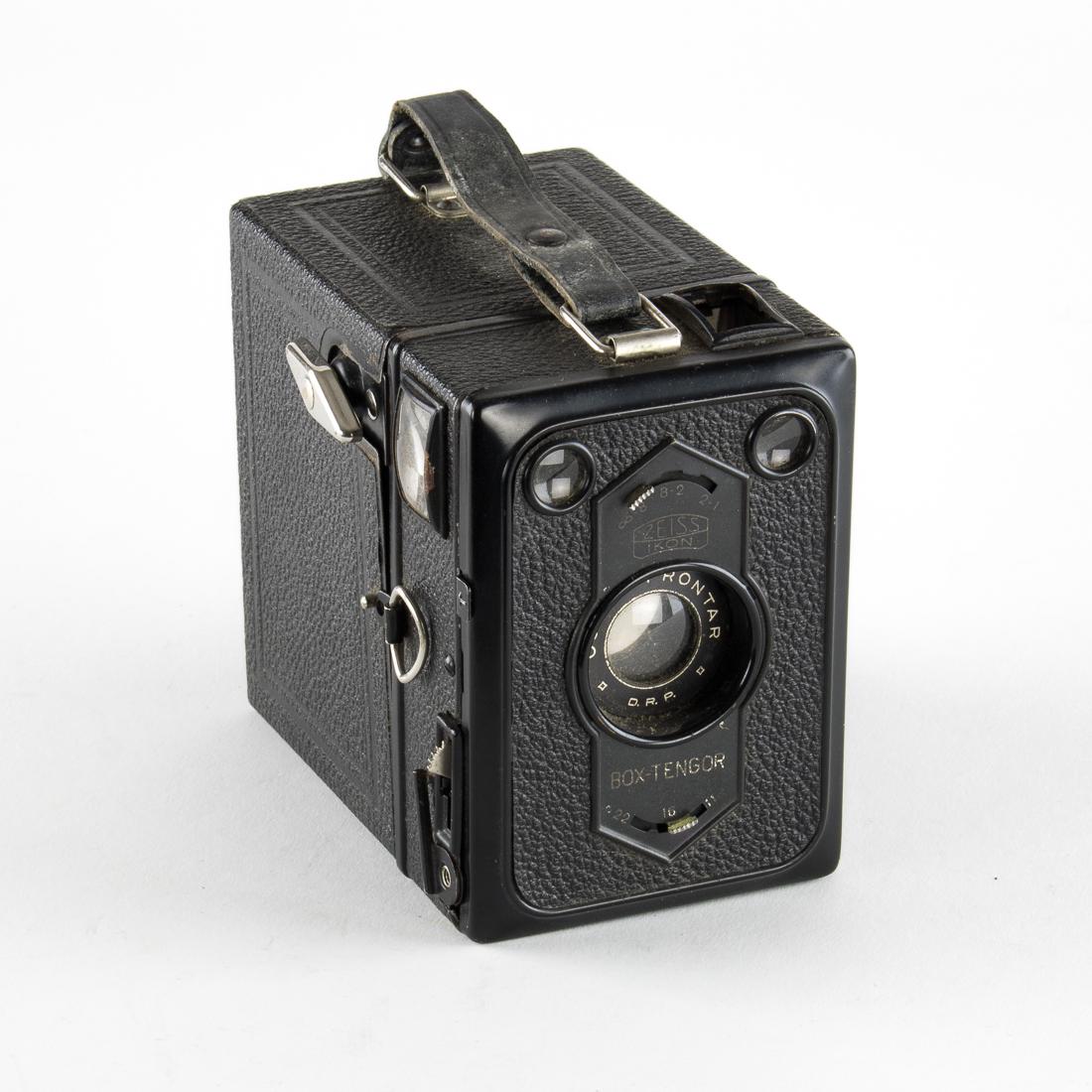 "KRAFT DURCH FREUDE" BOX CAMERA AND CASE: An unusual piece a box camera and case both bearing the logo of the N.S. Gemeinschaft â€œKraft durch Freude” program. The â€œBox-Tengor” camera was made by Zeiss Ikon in Dresden an