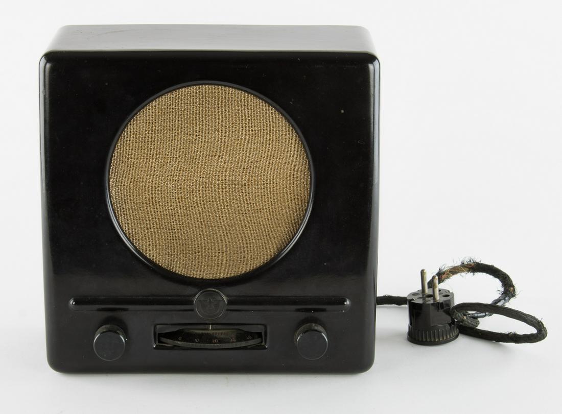 THIRD REICH "PEOPLEâ€™S RADIO": An evocative Third Reich artifact a very dark brown Bakelite "Volksempfanger" or "people's radio" 9.25 in. x 9.5 in. x 4.75 in. a "Deutsche Kleinempfanger" ("German 