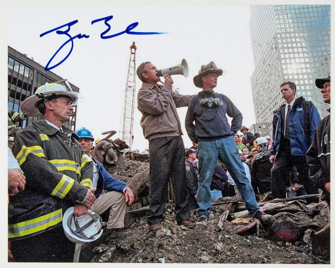 GEORGE W. BUSH: (b. 1946) Forty-third President of the United States who won his office after a hotly-contested election. S.P. 8 x 10 in. color an iconic view of the President addressing a group of first responders t