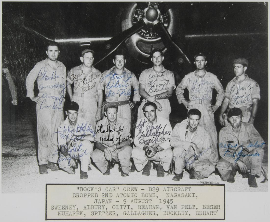 (ATOMIC BOMBING OF NAGASAKI) 'BOCKSCAR' CREWMEMBERS: Outstanding S.P., 9.5 x 7.5 in. b/w, a contemporary, vintage group image of eleven crewmembers of 'Bocks Car' in front of their plane, with each member signing on their likenesses and adding their ran