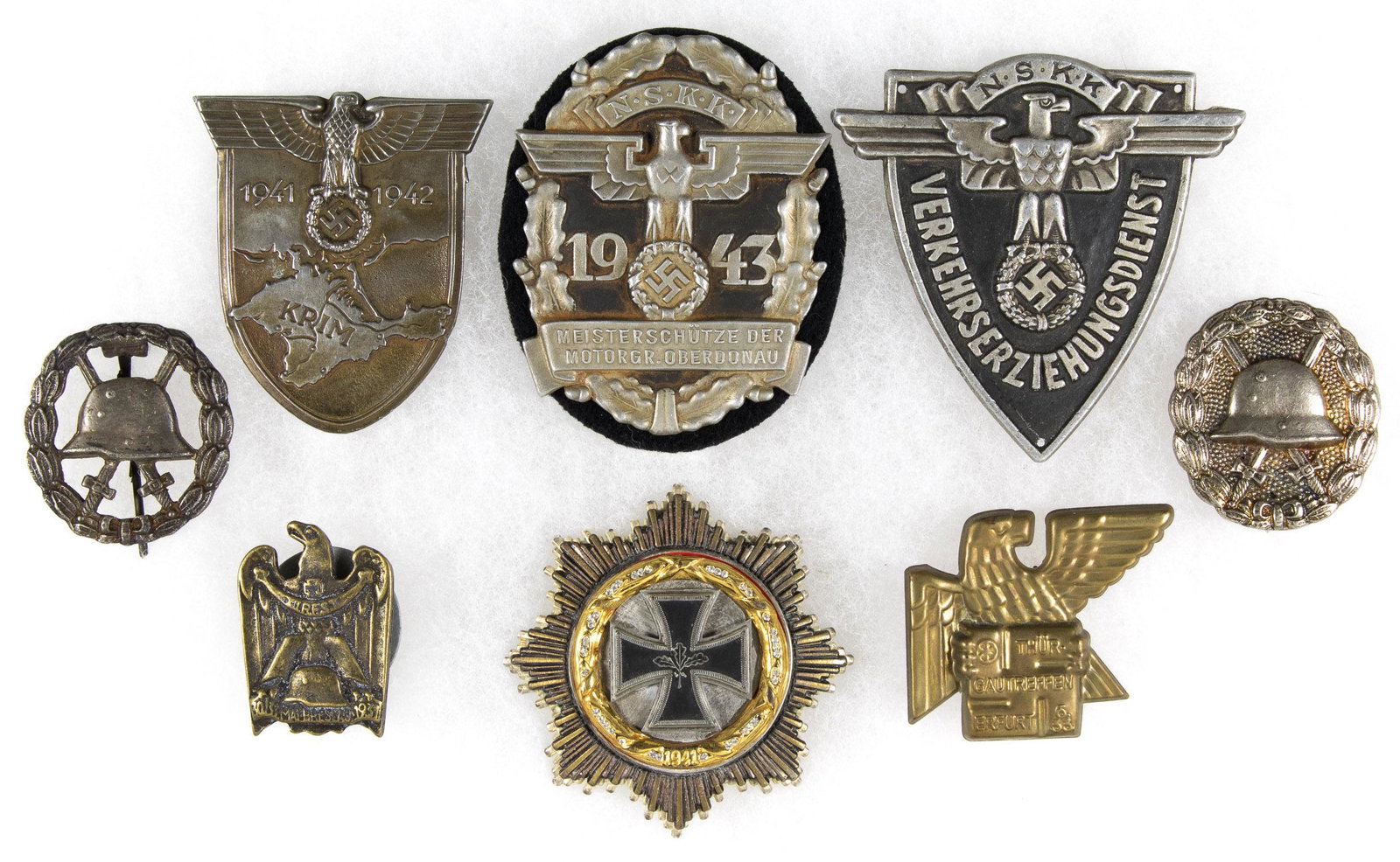 REPRODUCTION MEDAL GROUPING: Lot of eight reproduction medals, badges, etc. including German Cross in Gold with Diamonds, Wound Badges, N.S.K.K. shield and badge, Gau Treffen badge, Krim Shield, etc. Very good.