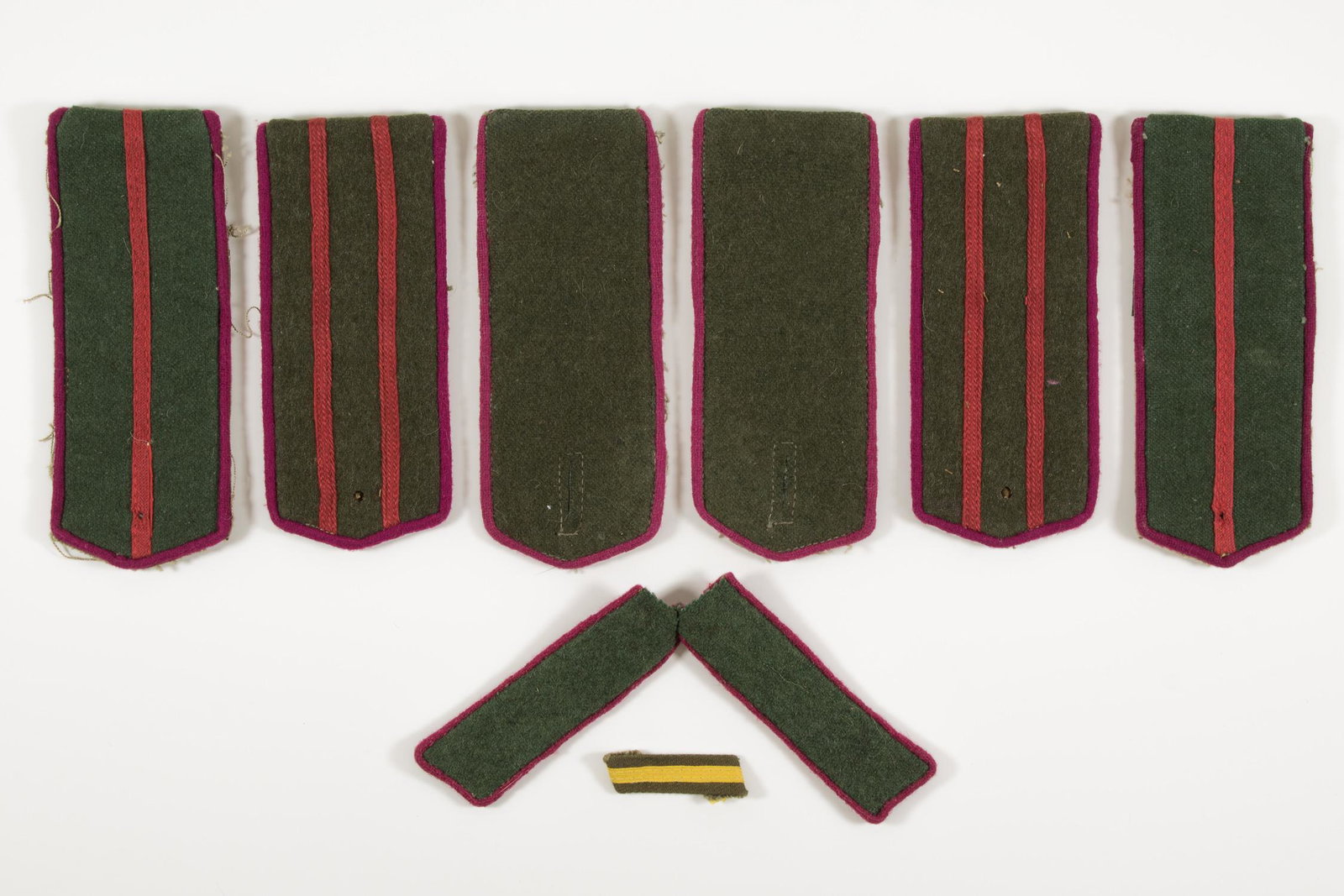 RUSSIAN UNIFORM INSIGNIA (8): RUSSIAN UNIFORM INSIGNIA (8)Lot of eight pieces of World War II Russian cloth uniform insignia. Includes three pairs of shoulder boards, one pair of collar tabs, and one wound stripe. Fine condition.