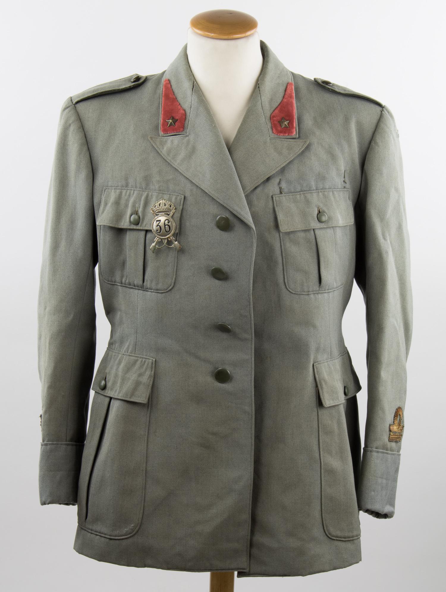 ITALIAN ALPINI MEDICAL CORPS OFFICER'S TUNIC: World War II Italian alpine medical corps officer's uniform, including a tunic constructed of a gray wool exterior with a tan rayon lining, fastened with four bakelite buttons at front, with four plea