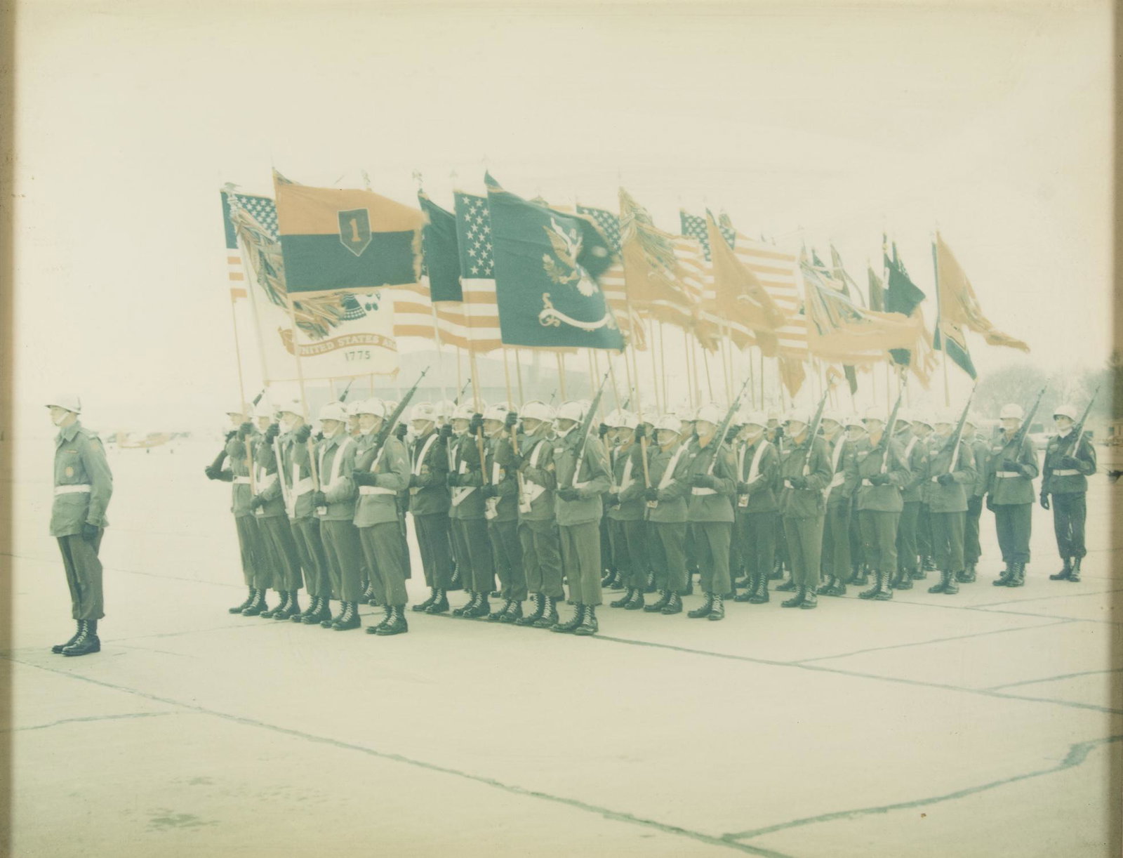 PHOTOGRAPH OF 1ST INFANTRY DIVISION, PRESENTED TO GEN.: FROM THE ESTATE OF GEN. CLARENCE R. HUEBNER, COMMANDER OF THE 1ST INFANTRY DIVISION IN THE FIRST WAVE AT OMAHA BEACH Attractive photograph, 13 x 10 in. (sight), showing soldiers of the 1st Infantry Di
