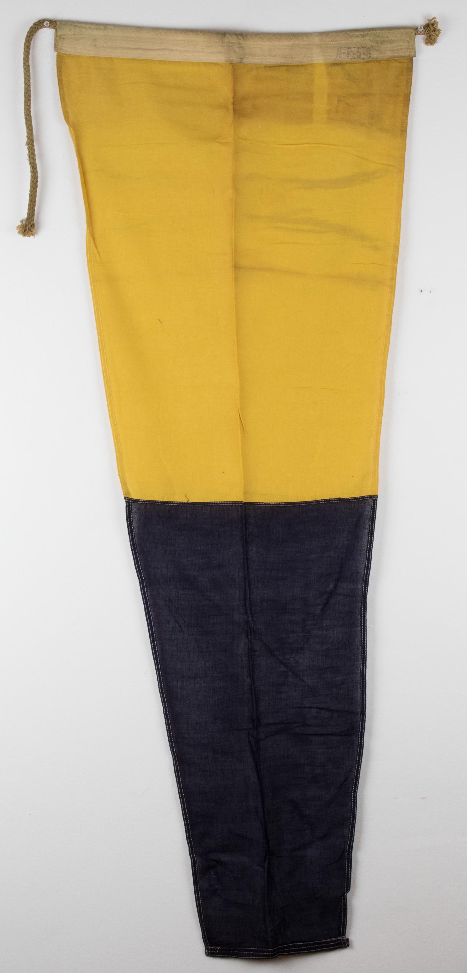 SIGNAL PENNANT FROM ADOLF HITLER'S YACHT 'AVISO GRILLE': Naval pennant, 21.5 x 58 in., constructed of dark blue and yellow cotton bunting, salvaged from the 'Aviso Grille', a Kriegsmarine dispatch boat used in the mid-1930s as a state yacht by Adolf Hitler.