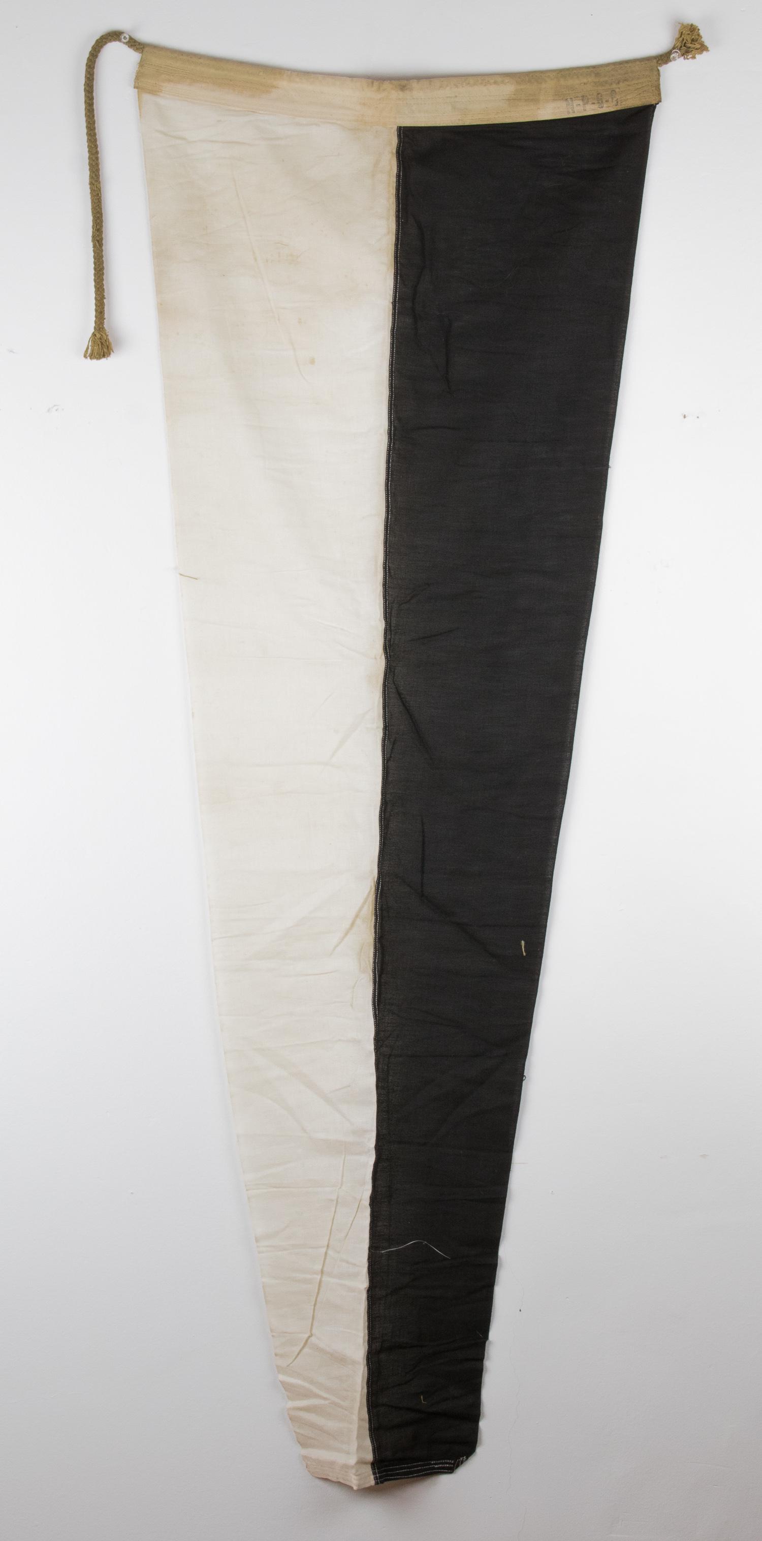 SIGNAL PENNANT FROM ADOLF HITLER'S YACHT 'AVISO GRILLE': Naval pennant, 21.5 x 58 in., constructed of two bars of white and black cotton bunting, salvaged from the 'Aviso Grille', a Kriegsmarine dispatch boat used in the mid-1930s as a state yacht by Adolf 