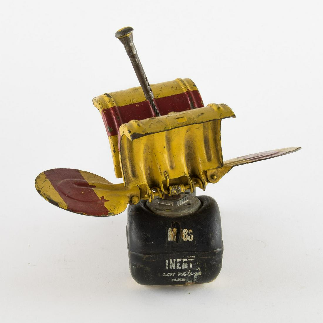 INERT AMERICAN 'BUTTERFLY' BOMB: An inert American 'M83' copy of a German SD2 'Butterfly Bomb', approx. 9 x 9 in., bearing red-and-yellow paint at the top and bearing a stamp reading in part: 'M 83...INERT...' Modeled after the Germa