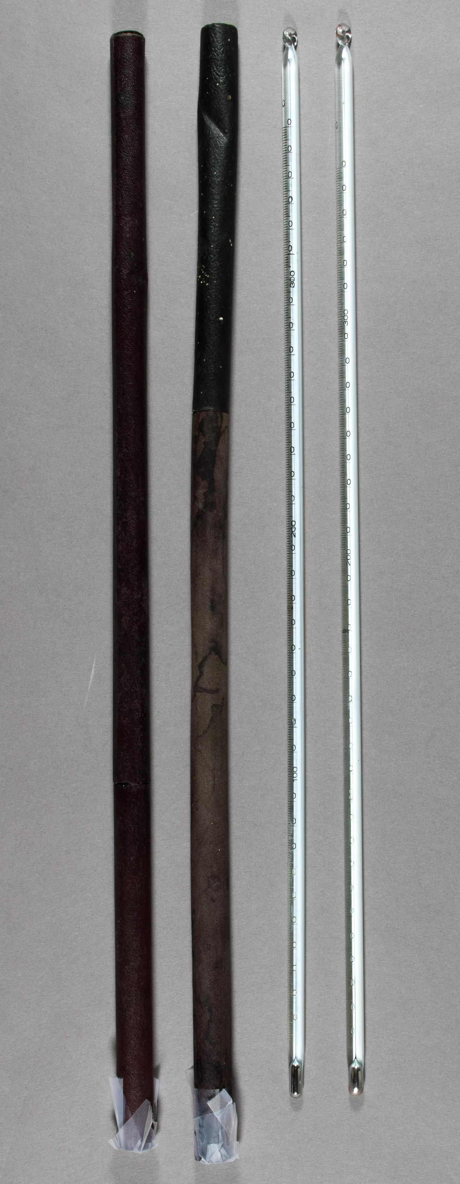 SCIENTIFIC MERCURY THERMOMETERS: Pair of mercury-and-glass thermometers, each 15.5 in., manufactured by Fischer Scientific Company in Pittsburgh. Sold with original cases, though one end of each is closed with scotch tape. Fine condi