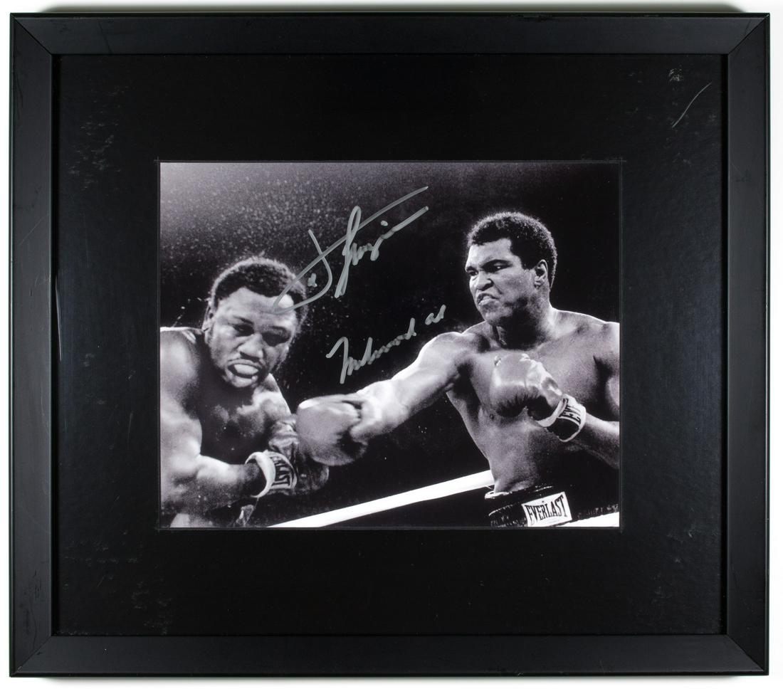 MUHAMMAD ALI & JOE FRAZIER: MUHAMMAD ALI & JOE FRAZIER Excellent signed photo, 10 x 7.75 in. b/w, view of legendary boxer MUHAMMAD ALI (1942-2016) delivering a stunning blow to his biggest rival, JOE FRAZIER (1944-2011). Both bo