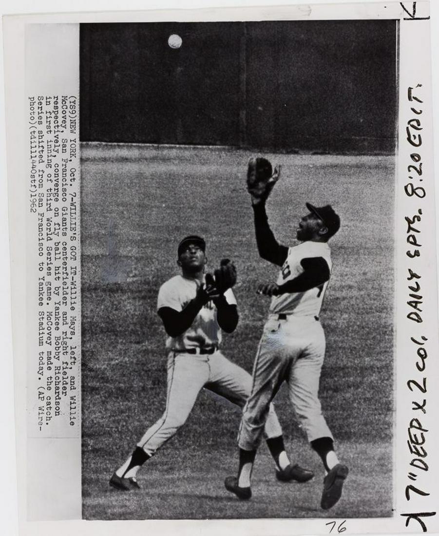 WILLIE MAYS IN THE WORLD SERIES: Two 8 x 10 in. press photos of baseball great Willie Mays in plays from the 1962 World Series, in one image nearly colliding with Willie McCovey while fielding a ball, in another Willie slides into se