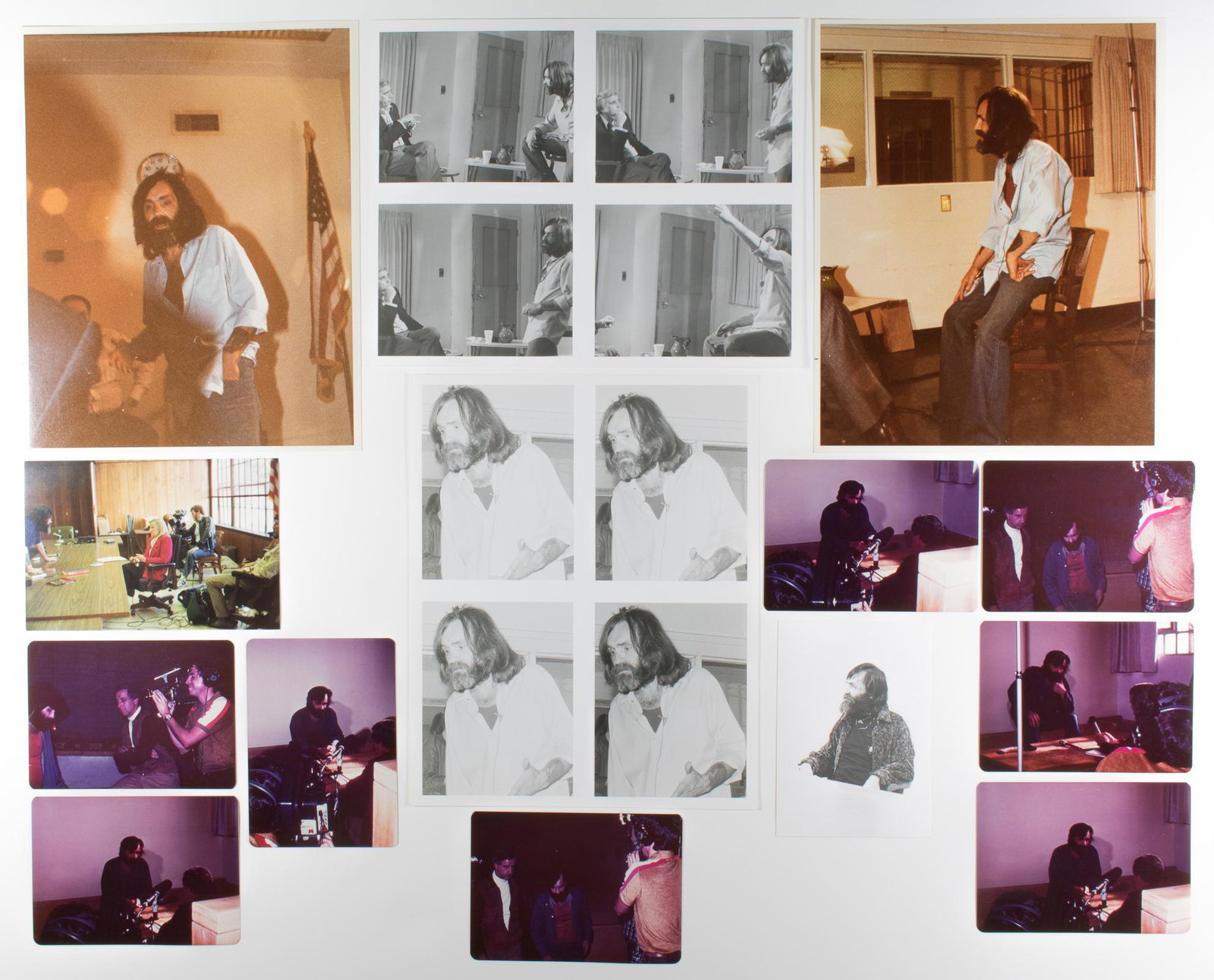 CHARLES MANSON PHOTOGRAPH GROUPING: Lot of fourteen original candid photographs of Charles Manson, most taken during prison interviews ca. 1975-1982, some 3.5 x 5 in., others 8 x 10 in., most color. Fine. From the estate of Manson's bio