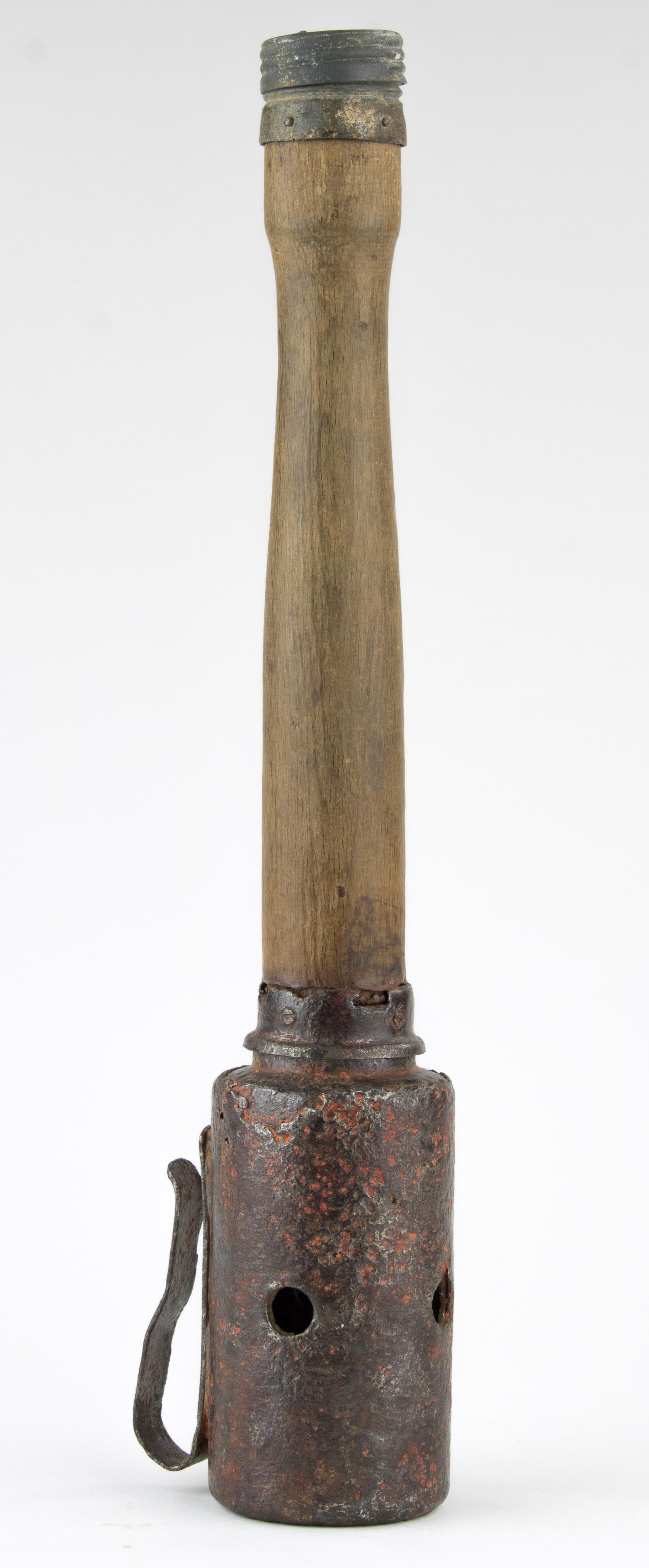 GERMAN MODEL HAND GRENADE: Practice 'potato masher' hand grenade, identical in all respects to a genuine example in weight and size. 14.5 in. long, bottom cap is a single piece and unscrews showing the rarely encountered white 