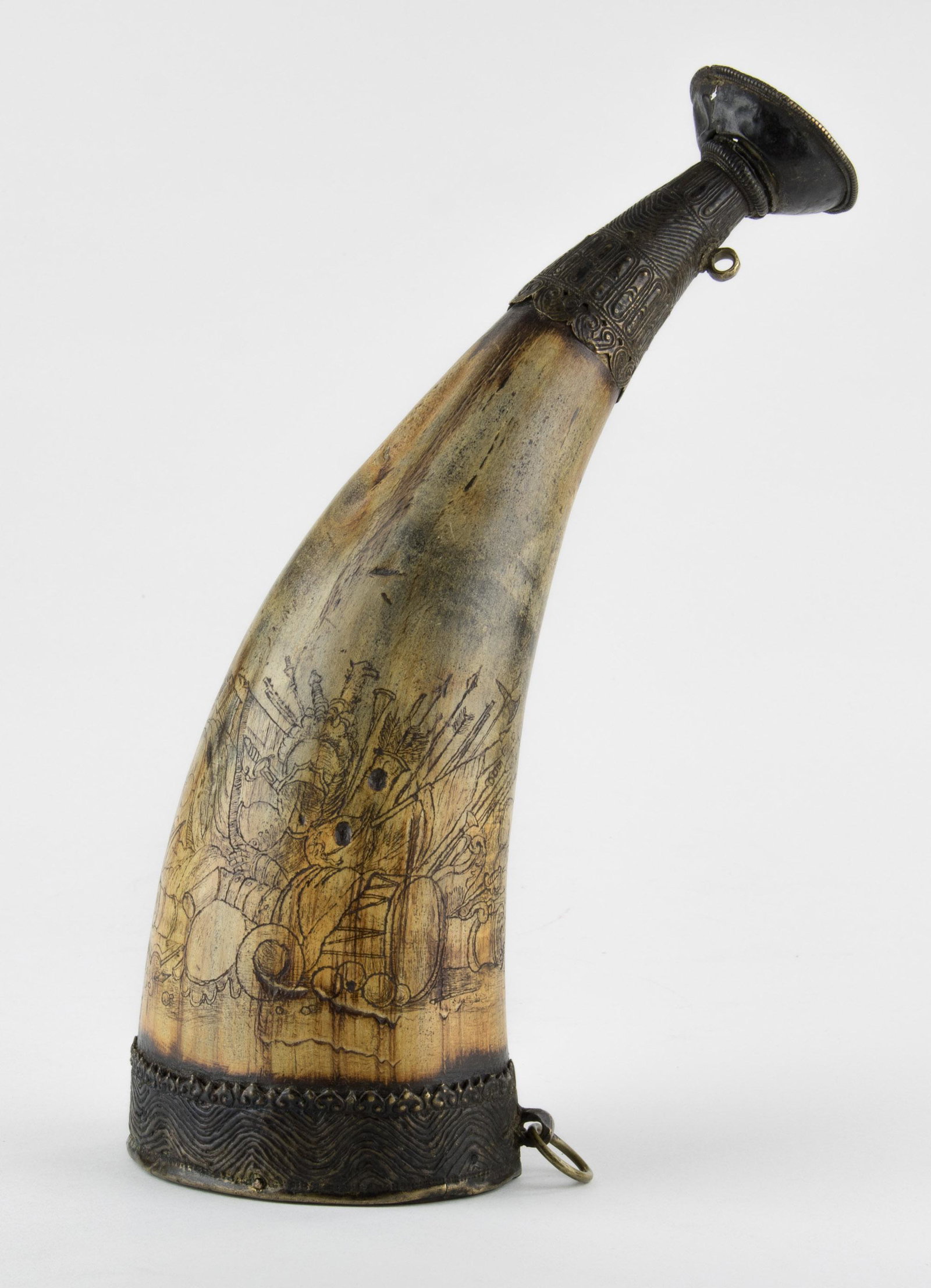 SERINGAPATAM CARVED POWDER HORN: Finely engraved wooden powder horn, 15 in. long with ornate brass work on each end, one side featuring assorted military scenes, including cannons, powder kegs, swords, spears, and various munitions, 