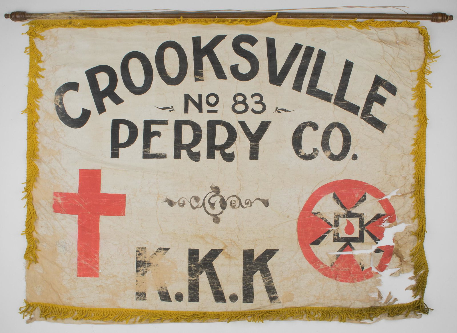 KU KLUX KLAN HANGING BANNER: An incredibly rare relic from the Ku Klux Klan, a clearly handmade banner from the Klan's provincial group in Perry County, Ohio, likely stemming from the early 1900s. The cloth banner, 33.5 x 45 in.,