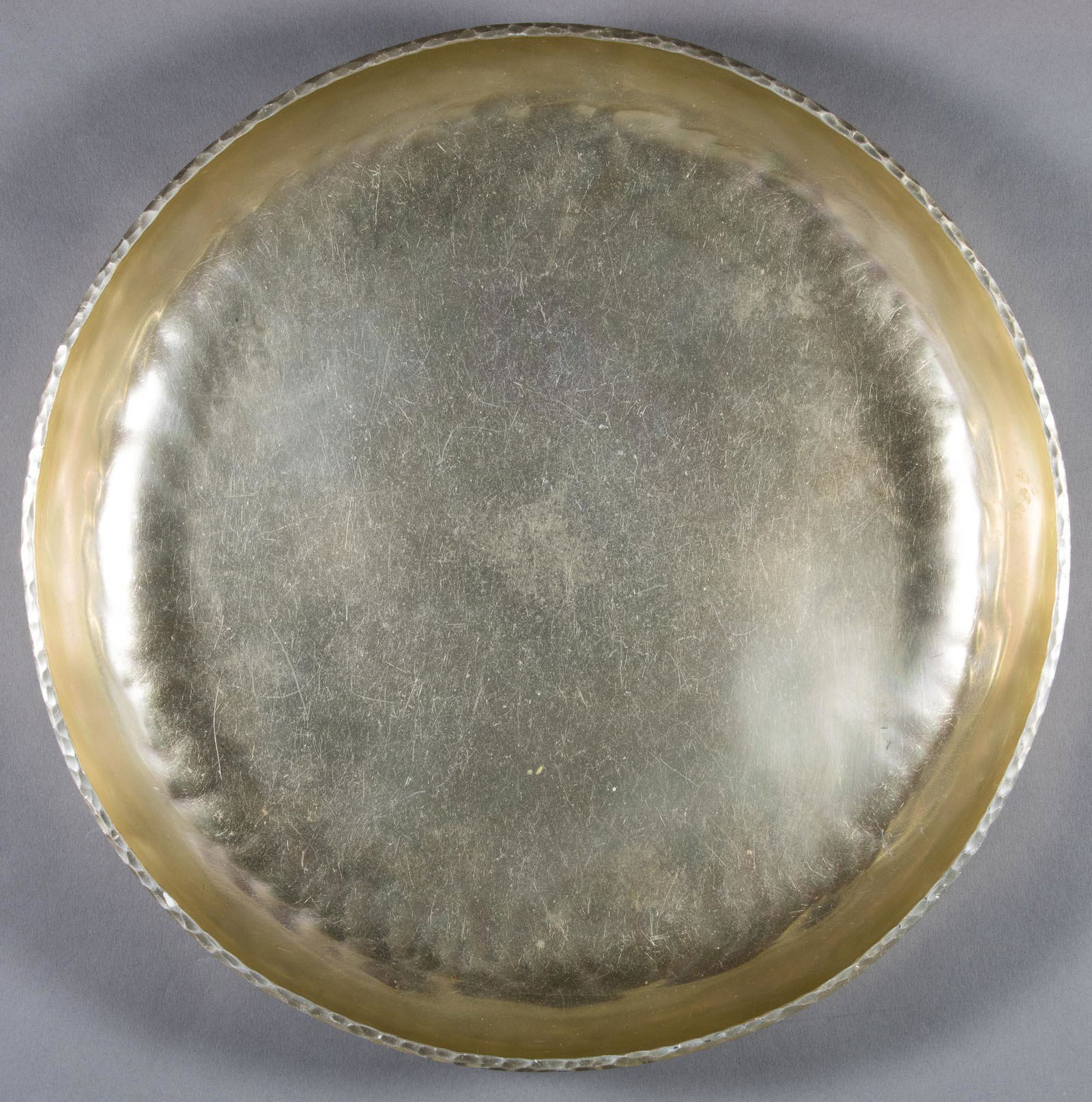 ZEPPELIN ALUMINUM BOWL: A fine aluminum dish, 10 in. dia., likely from the interwar period, used as tableware aboard a German zeppelin. There is a slightly ribbed design around the curve of the base as well as on the rim. Th