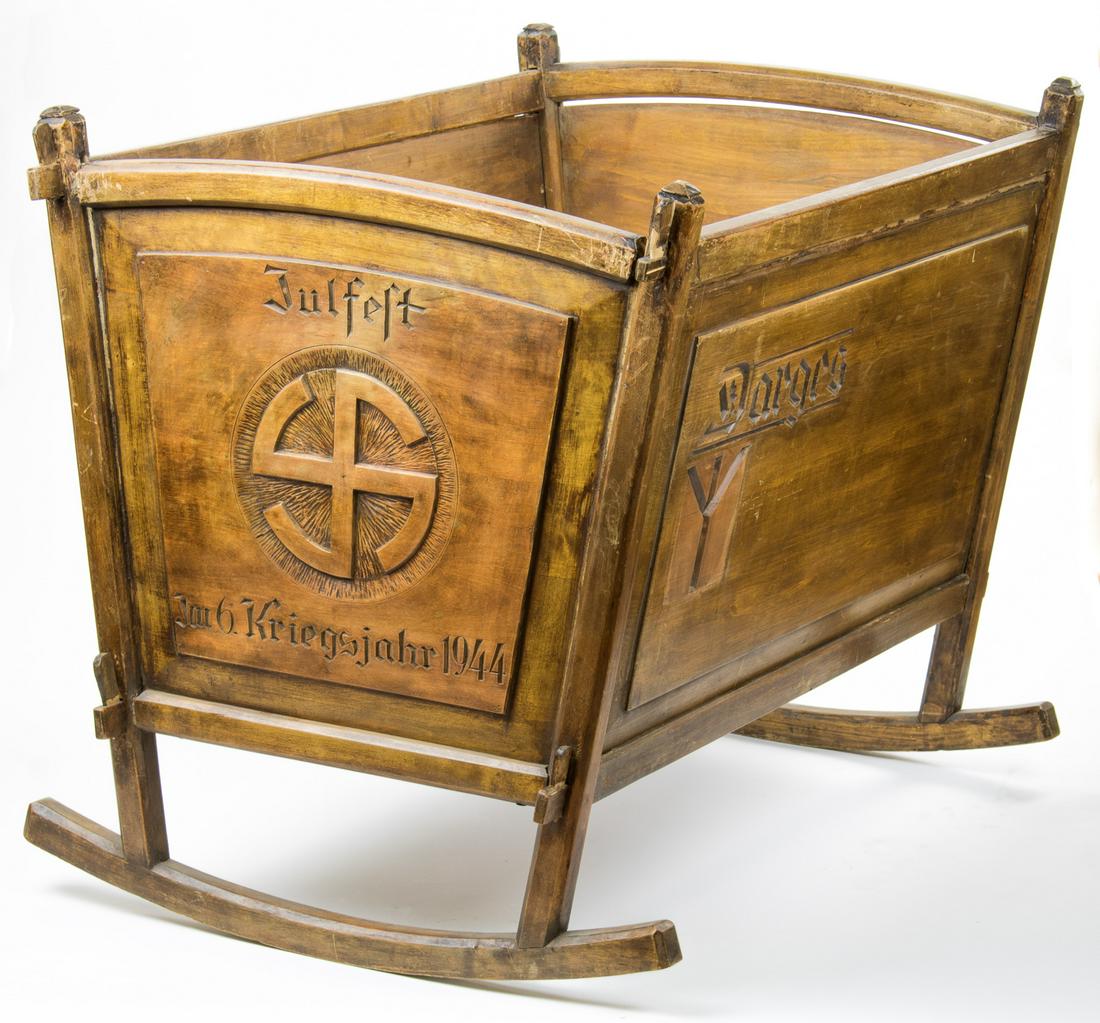 S.S. CRADLE GIFTED TO HITLER'S ADJUTANT FRITZ DARGES: An excessively rare SS relic with impeccable provenance, a cradle once gifted to SS-Obersturmbannfuhrer FRITZ DARGES (1913-2009), recipient of the Knight's Cross and adjutant to both Martin Bormann an