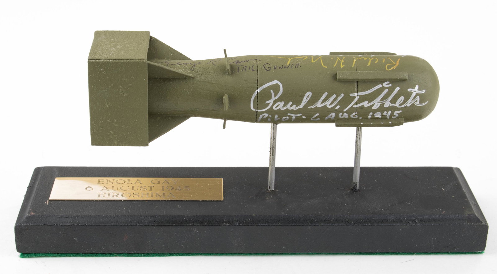 'ENOLA GAY' SIGNED ATOMIC BOMB MODEL: An excellent wooden model of the atomic bomb 'Little Boy' dropped on Hiroshima on August 6, 1945, 7 x 1 x 2 in., signed by five of the crew members of the Enola Gay, including PAUL TIBBETS (who adds '