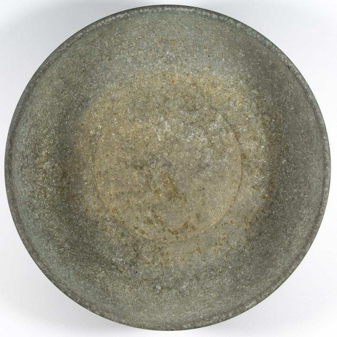 CONCENTRATION CAMP ALUMINUM BOWL: Aluminum mess plate, 11.5 in. diameter, stamped with SS runes on the bottom. The plate is heavily worn and oxidized but the runes remain evident. This bowl, in 'dug' condition, is very reminiscent of 