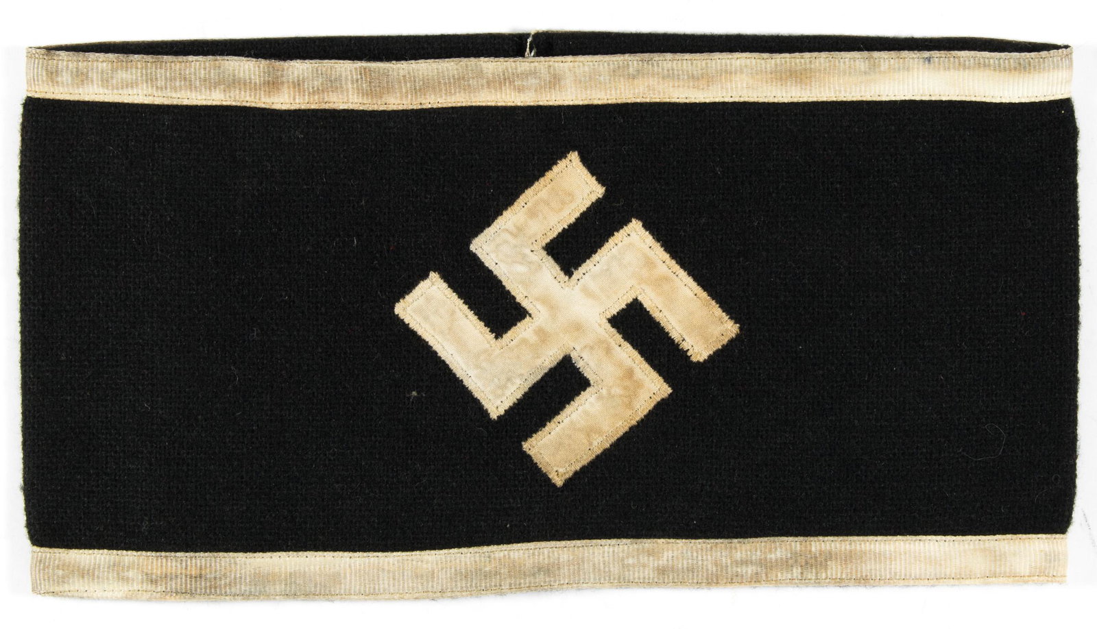DANISH NSDAP ARMBAND: Rare black wool armband, 9 x 4.5 in., with a one-piece sewn-on white fabric mobile swastika at center, and with white ribbon trim at the edges. Armbands of this type were worn by the 'Danmarks Nationa