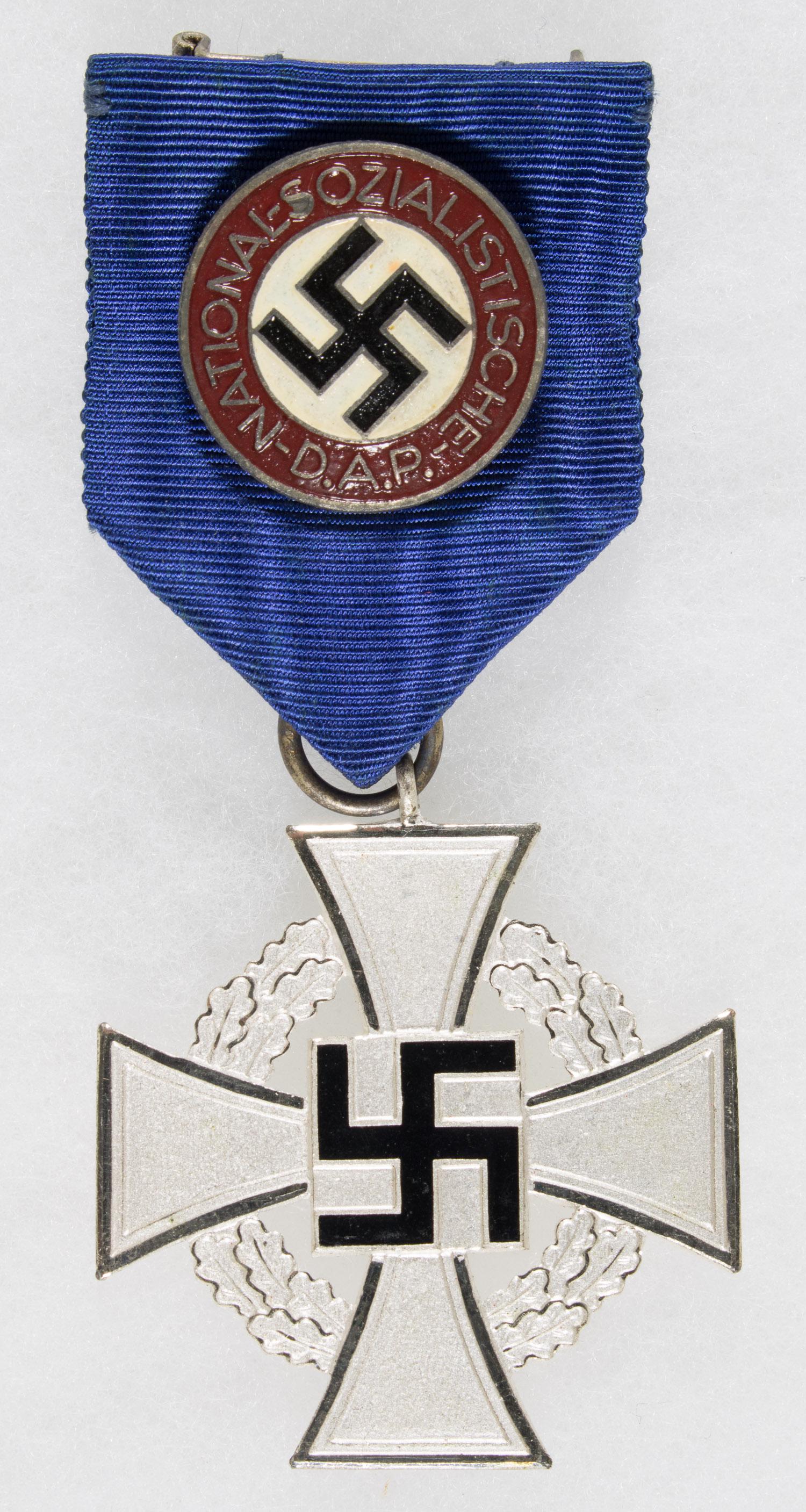 NSDAP 25 YEAR SERVICE MEDAL WITH D.A.P. PIN Very: NSDAP 25 Year Silver Service Medal with original blue ribbon, with circular 'NATIONALSOZIALISTISCHE D.A.P.' attached to it, as found, and marked 'RZM M1/34'. Very fine.