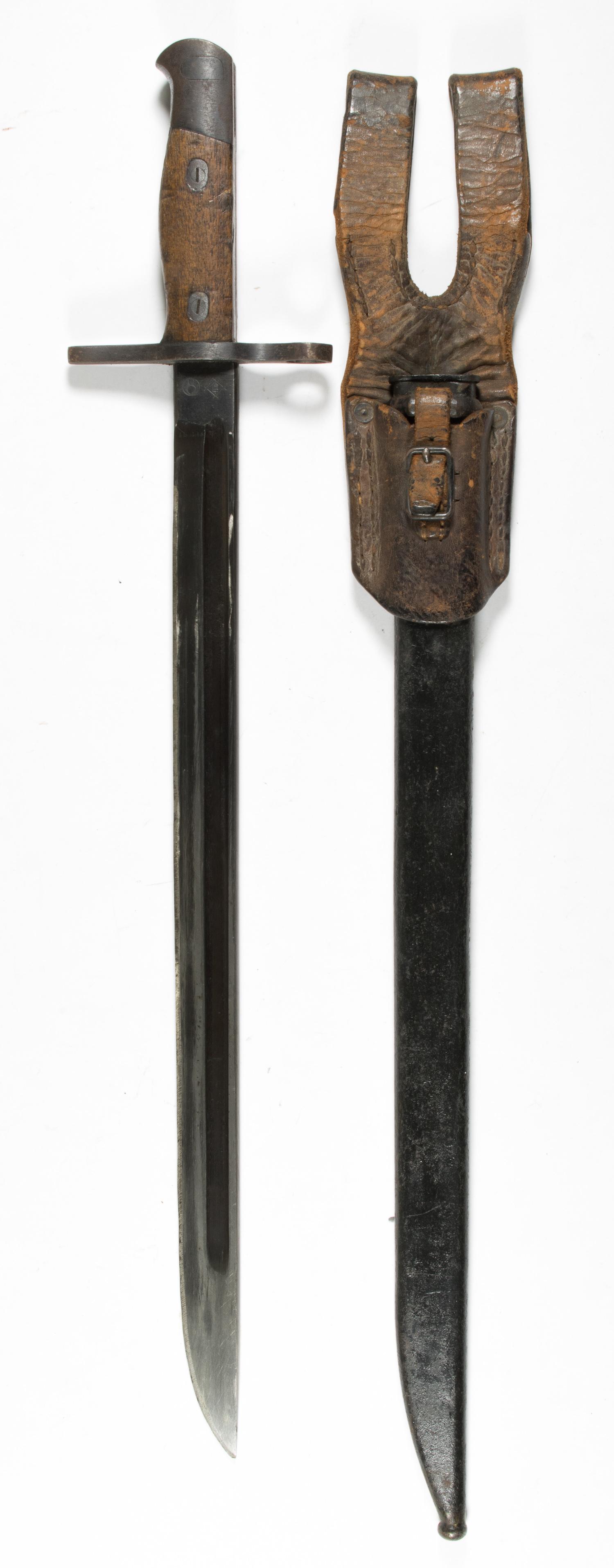 JAPANESE BAYONET WITH SCABBARD AND FROG: Japanese bayonet, 15.75 in. blade, 20 in. overall, with wood handle, straight guard, and maker's marks on the ricasso. The end of the pommel bears the serial number '41769'. Sold with original metal s