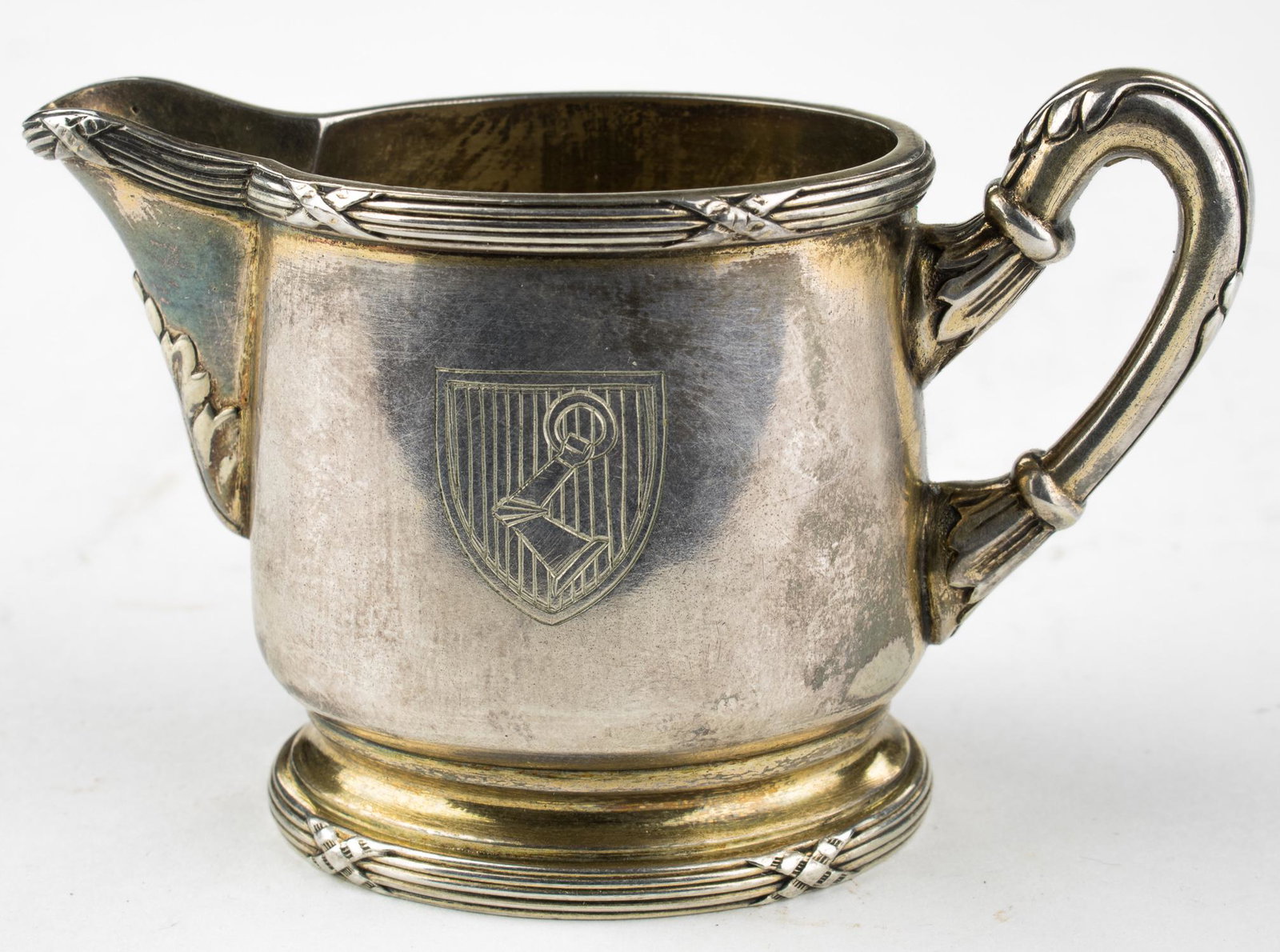 HERMANN GORING PERSONAL CREAMER PITCHER: A fine small silver creamer pitcher, 2 in. x 1.5 in. dia., with a 1 in. long spout, an open-top, and curved handle. The side of the pitcher is engraved with the family crest of Luftwaffe commander Her