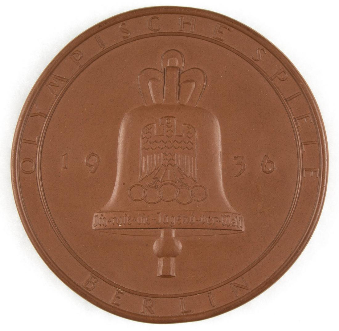 1936 BERLIN OLYMPICS PLAQUE BY MEISSEN: Scarce Meissen clay plaque from the 1936 Berlin Olympics, 4.5 in. dia., marked on the front with the Olympic bell and the label 'Olympic Games Berlin 1936 - I call the youth of the world'. The back be