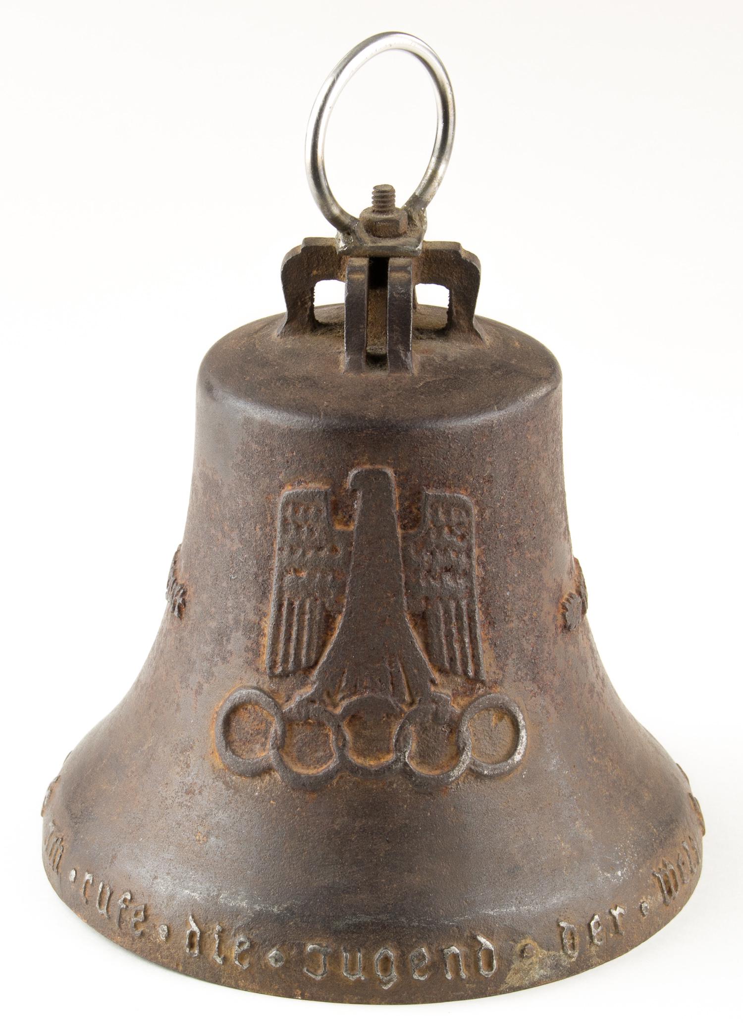 1936 BERLIN OLYMPICS TRACK OFFICIAL'S BELL: A very rare track official's bell from the XI Olympic Games in Berlin 1936. The cast cast steel bell bears a national eagle grasping Olympic rings, an image of the Brandenburg Gate and dates '1. - 16.