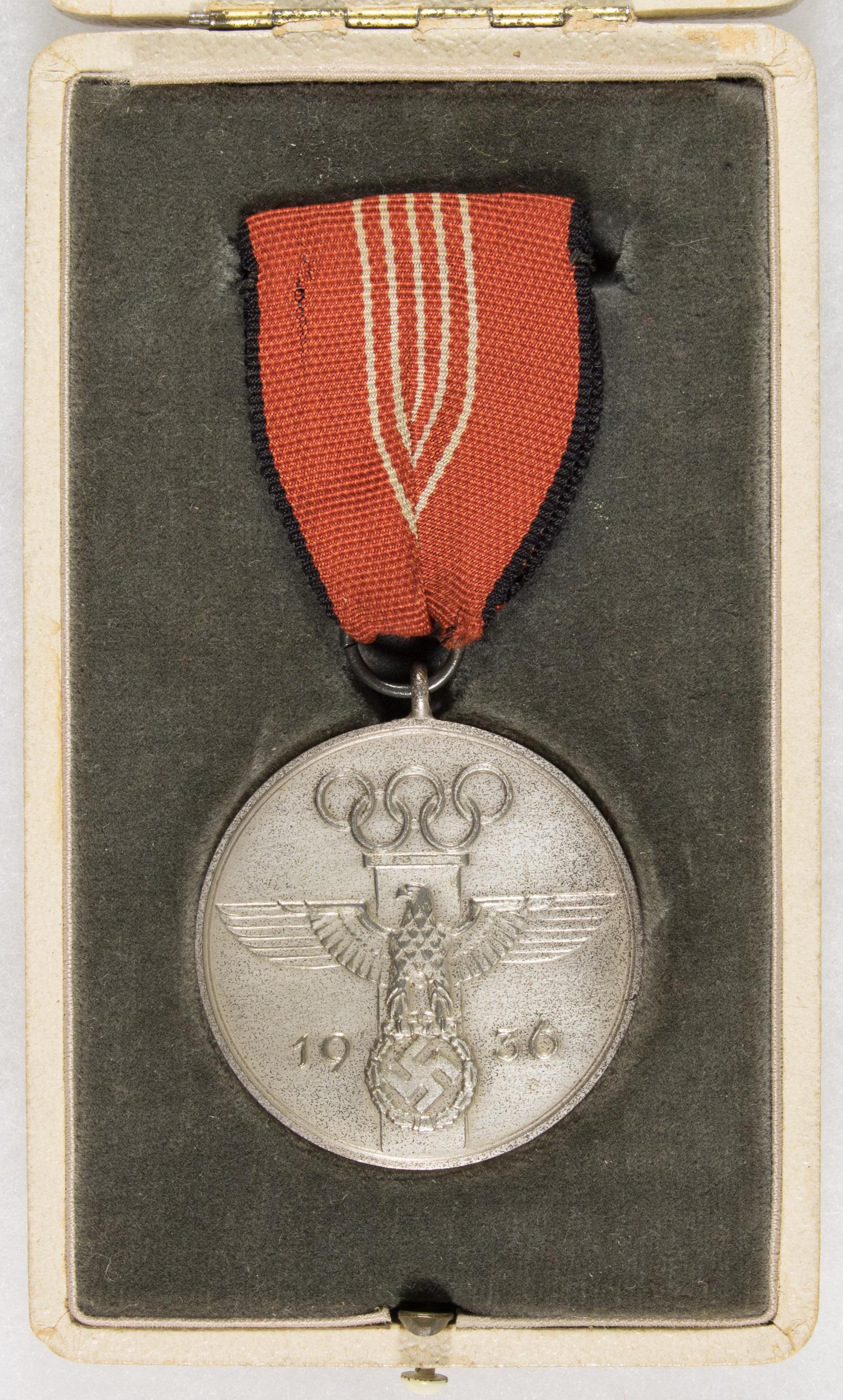 1936 GERMAN OLYMPIC MEMORIAL MEDAL WITH CASE: Scarce example of a cased Olympia-Erinnerungsmedaille, or 'German Olympic Memorial Medal', instituted July 31st 1936 for services rendered to the 1936 Olympic Games. The medal is silver-plated, die-st
