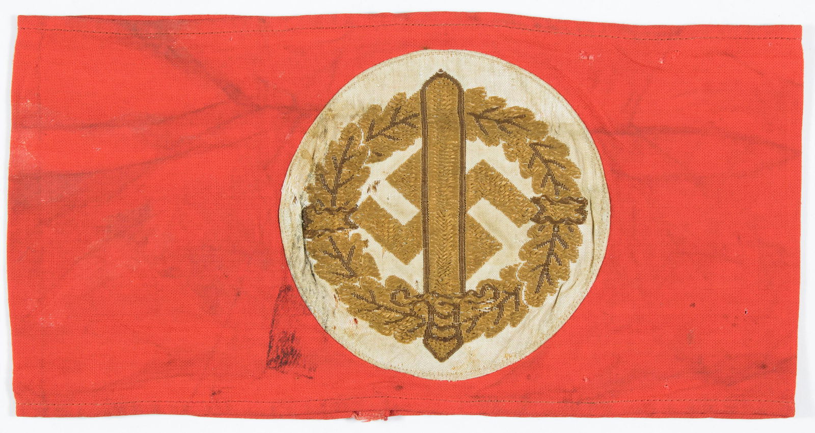 S.A. SPORTS ARMBAND: S.A. Sports armband worn by participants in S.A. sports competitions, 16 x 4 in. cotton with embroidered sword, oak leaves and swastika, joined at rear. With paper RZM tag within. Light staining, else