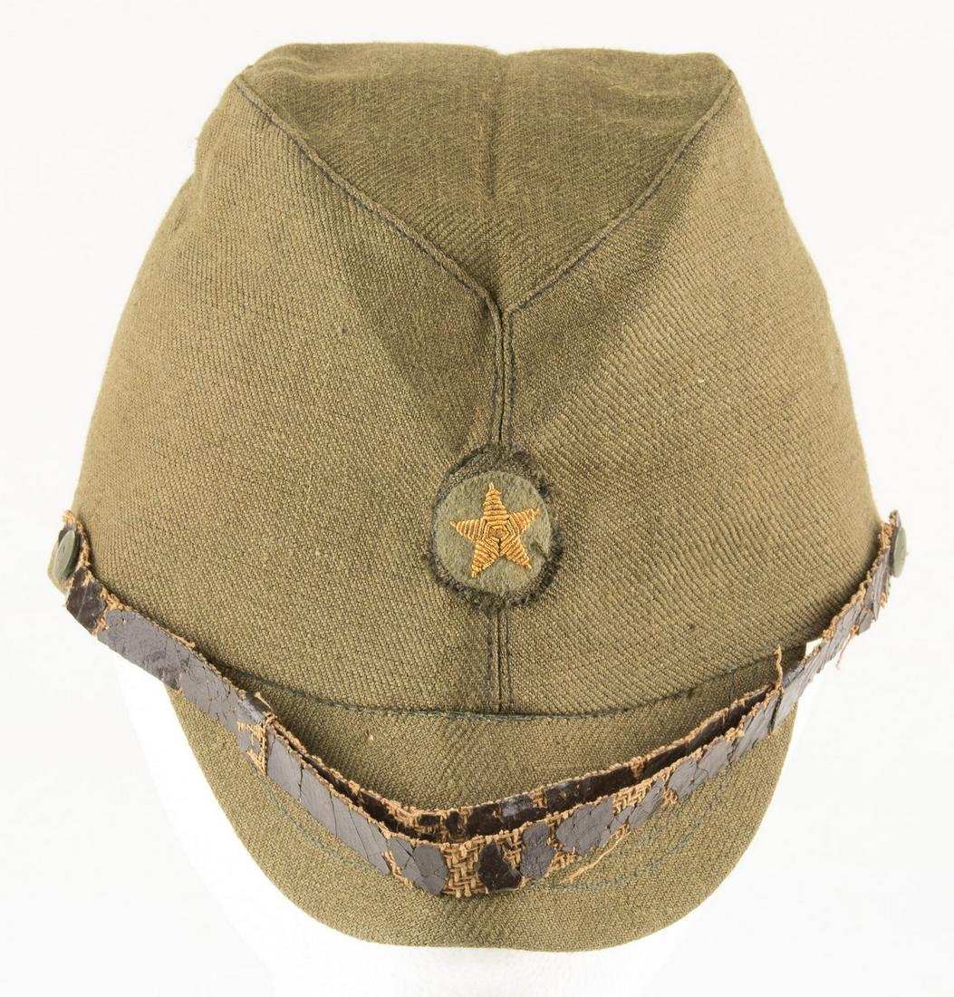 JAPANESE ARMY CAP: Japanese army field cap with visor, dark green wool with mesh lining, leather chinstrap and sweatband. Sewn to the front is a gold metal wire star insignia. Unknown Japanese stamp in the interior. Swe