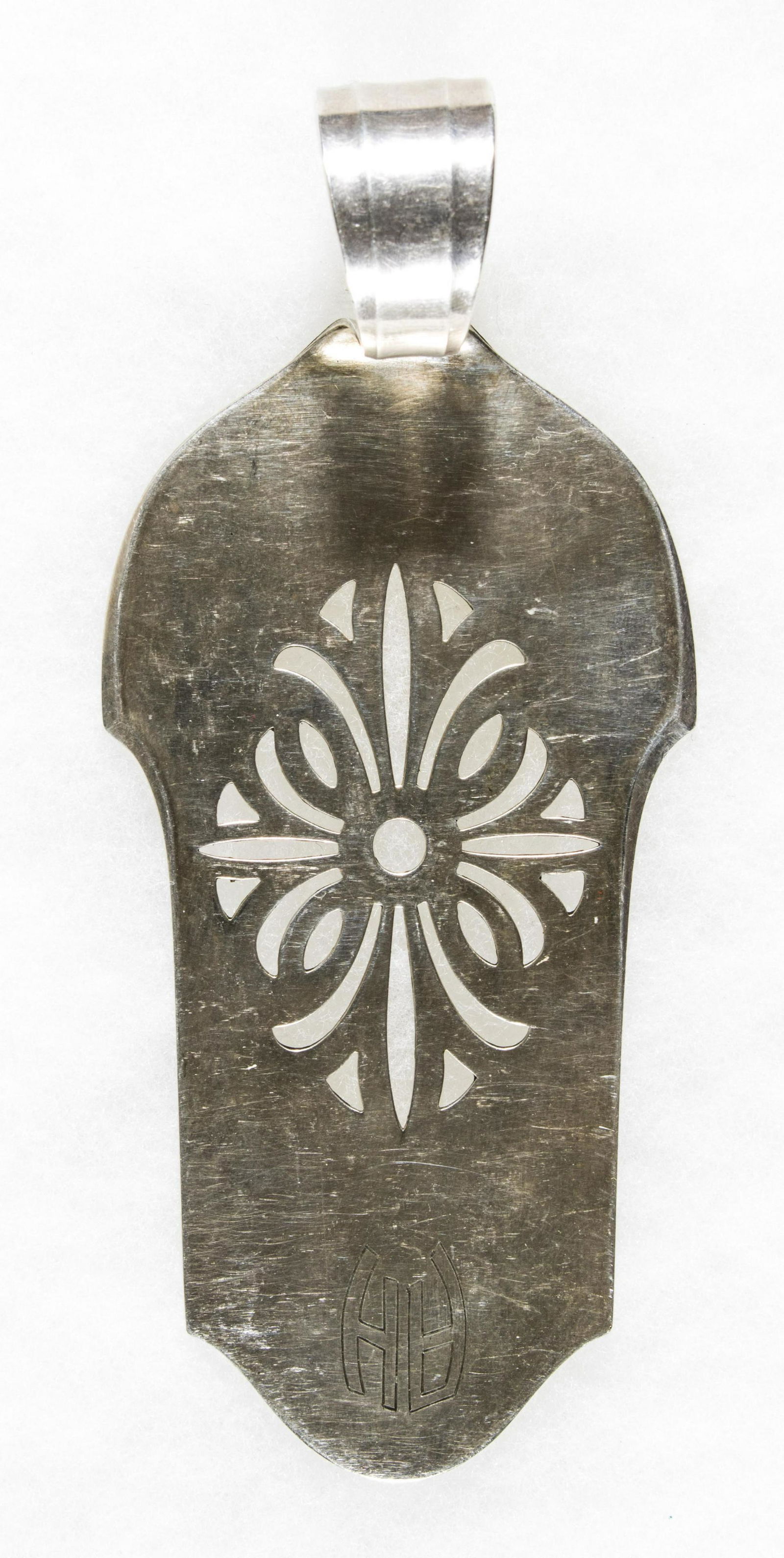 ADOLF HITLER PASTRY SERVER: A small, silver plated pastry serving utensil, consisting of a flat 4.25 x 2.5 in. body and a 1 in. curved handle the end. The flat portion of the server is engraved with a simple flower while the top