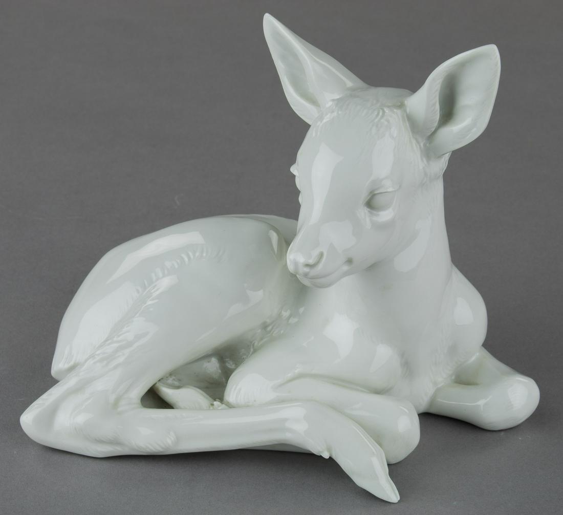 ALLACH LYING FAWN NO. 41: Allach white porcelain figure of a deer fawn looking at the viewer as he lays upon the ground, approx. 6.5 in. tall, marked on the base with the name of the designer: 'PROF T. KARNER 41' and with gree