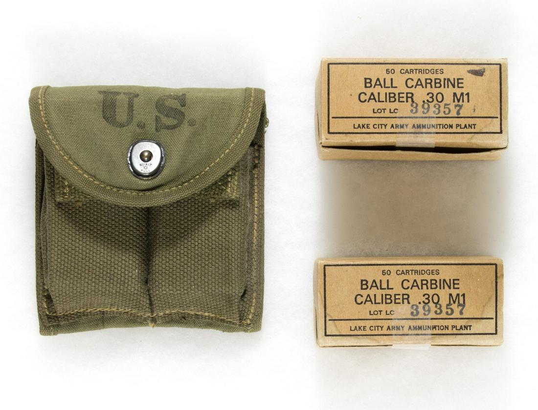 M1 CARBINE MAGAZINES, POUCH, AND AMMO: A World War II era stock ammo pouch for the M1 Carbine rifle, stamped 'US' on the front and marked 'R.B. Hanson Co. 1943', containing two magazines filled with .30 cal. ammo. Sold with two boxes of .3