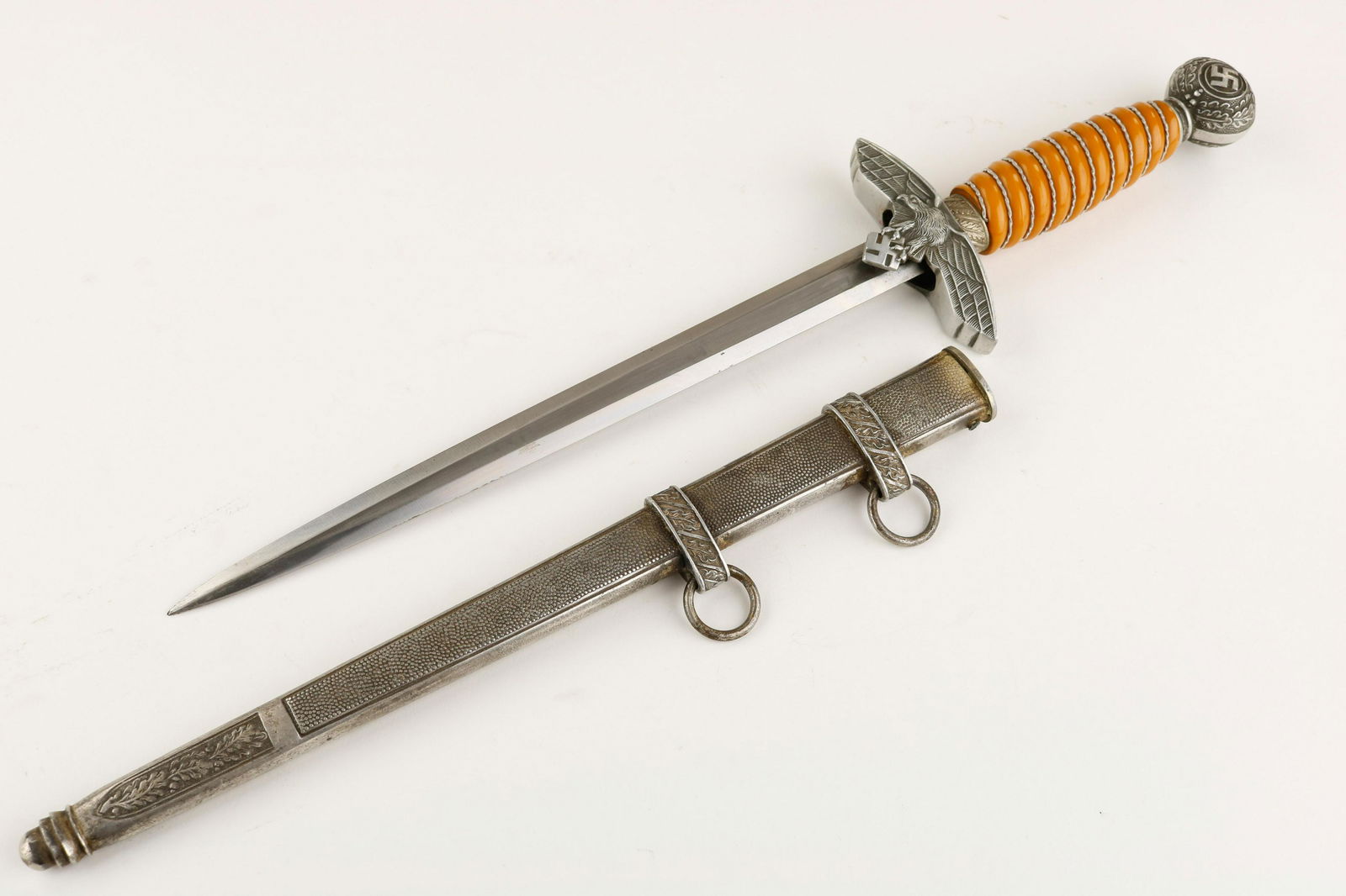 LUFTWAFFE DAGGER, SECOND MODEL BY WKC: Fine condition Luftwaffe dagger with scabbard, made by WKC, Solingen. Starting at the top, this dagger's round pommel nut with swastika still retains excellent detail, with only two of the oak leaves