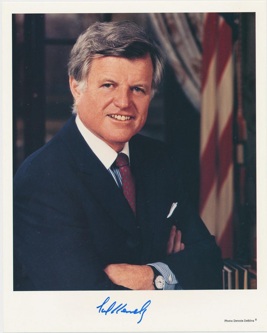 EDWARD KENNEDY: (1932-2009) Democratic senator from Massachusetts, brother of John F. Kennedy and Robert Kennedy. S.P., 8 x 10 in. color, a standing chest-up portrait, signed in blue ink at the lower margin. In fine