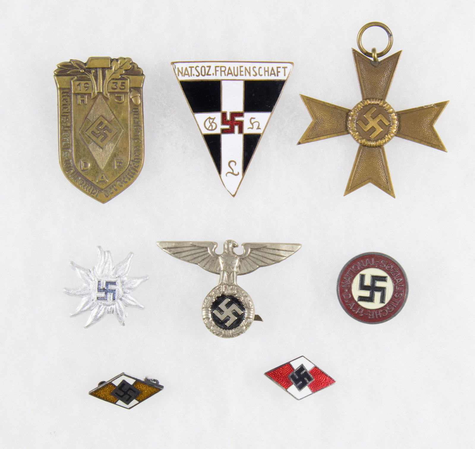 WORLD WAR II GERMAN MISCELLANY (8): Balance of a collection, eight German items from World War II. Includes: NSDAP party pin, RZM marked on the reverse ‘M1/17’; Edelweiss pin with a swastika at the center; enameled National 